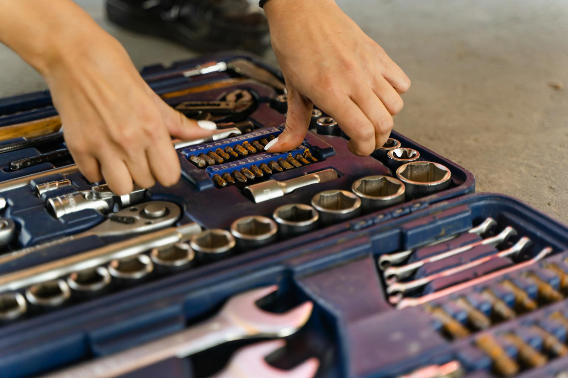 An organized toolbox with many compartments holding different tools